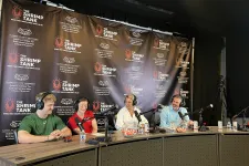 Thumbnail for Four hosts with microphones and headphones recording podcast at The Shrimp Tank studio with branded backdrop.