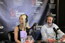 Thumbnail for Two podcasters with headphones speaking into microphones at The Shrimp Tank podcast set with FAU branding.