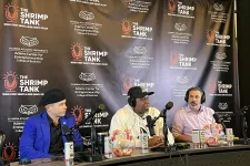 Thumbnail for Three men speaking into microphones during The Shrimp Tank podcast with branded backdrop and shrimp bowls.