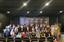 Thumbnail for Large group of diverse young adults and professionals posing on stage in front of a Shrimp Tank event banner