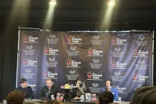 Thumbnail for Panel of four speakers at The Shrimp Tank event with branded backdrop and audience in foreground
