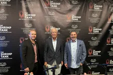 Thumbnail for Three men standing in front of The Shrimp Tank podcast backdrop with microphones and headphones on table