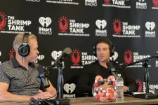 Thumbnail for a couple of men wearing headphones and sitting at a table with microphones