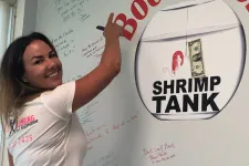 Thumbnail for a person posing in front of a white board with writing on it