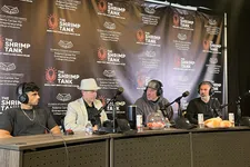 Thumbnail for Four men seated at podcast table with microphones under The Shrimp Tank backdrop at Florida Atlantic University event.
