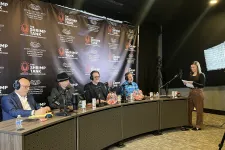Thumbnail for Four judges seated at a panel with microphones and headsets, a woman standing with notes in a podcast studio setup.