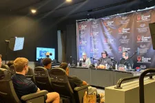 Thumbnail for Podcast recording session with live audience seated in a studio featuring Shrimp Tank branding backdrop and microphones.