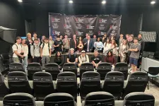 Thumbnail for Group of diverse young adults and professionals posing in front of a Shrimp Tank branded backdrop in a studio.