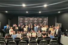 Thumbnail for Group of diverse people posing in front of Shrimp Tank Media branding backdrop in a studio setting