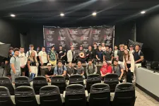 Thumbnail for Group of diverse young adults posing in a studio with Shrimp Tank media event backdrop and professional lighting.