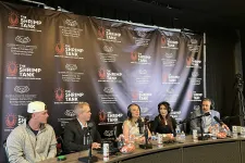 Thumbnail for Panel of five speakers with microphones at The Shrimp Tank event backdrop discussing entrepreneurship.