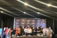 Thumbnail for Group of people posing in front of The Shrimp Tank event backdrop on stage with awards and trophies