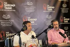 Thumbnail for Two men wearing headphones speaking into microphones during The Shrimp Tank podcast recording with branded backdrop