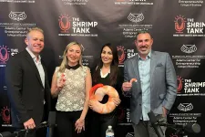Thumbnail for Four business professionals pose in front of The Shrimp Tank branded backdrop holding shrimp-themed items at a podcast setup.