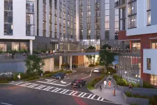 Thumbnail for Modern mixed-use development with Pursuit Hotel, residences, elevated walkway, and people in urban setting at dusk.