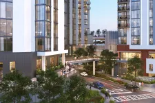 Thumbnail for Modern residential buildings with glass facades, greenery, and pedestrians near a street and pedestrian bridge.