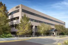 Thumbnail for Modern office building with large windows, trees, and clear blue sky at 790 address.