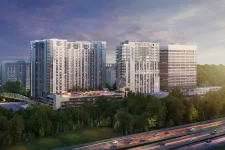 Thumbnail for Modern residential and office buildings beside a highway with trees and a colorful sunset sky.