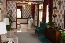 Thumbnail for a living room filled with furniture and vase of flowers on a table