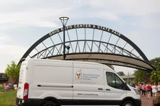 Thumbnail for White Ronald McDonald House Charities van parked near Ohio Expo Center & State Fair entrance on a cloudy day.