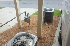 Thumbnail for Atlanta Doraville AC Repair by The Air Company of GA. Outdoor air conditioning units installed beside a porch with pine needle ground cover and nearby gas meter