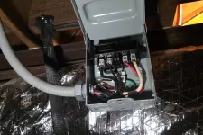 Thumbnail for Atlanta HVAC Residential Repair by The Air Company of GA. Open electrical junction box with connected wires mounted near insulated ductwork in a basement.