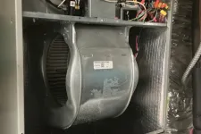 Thumbnail for Interior of HVAC unit showing blower wheel, wiring, and ventilation components inside metal casing.