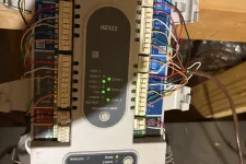 Thumbnail for HZ322 HVAC control board showing wired connections and status LEDs in an attic space.