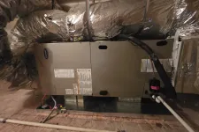Thumbnail for Carrier HVAC unit installed in a basement with insulated ductwork and connected pipes and wires.