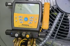 Thumbnail for Fieldpiece SMAN refrigerant manifold gauge connected to HVAC unit measuring pressure and vacuum.
