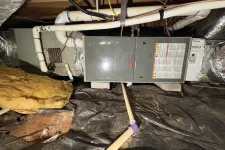 Thumbnail for HVAC furnace and ductwork installed in a basement crawl space with insulation and pipes visible