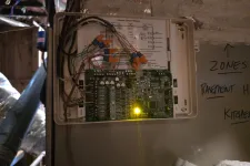 Thumbnail for Open control panel showcasing complex wiring and electronic circuit board with glowing yellow indicator light