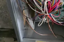 Thumbnail for Open electrical panel with multicolored wires connected to circuit board inside metal enclosure.