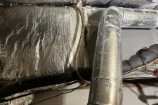 Thumbnail for Insulated HVAC ductwork and metal air pipes inside a building ceiling space with electrical wiring.