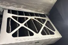 Thumbnail for Close-up of a pleated air filter with a sturdy frame and efficiency rating labels inside an HVAC system.