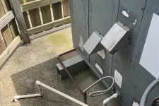 Thumbnail for Goodman HVAC unit installed outdoors with connected white and metal piping beside wooden fence on concrete ground.