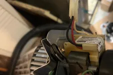 Thumbnail for AC Cooling Repair in Atlanta Brookhaven 30319 by The Air Company of GA.  Electric motor with wires and metallic parts in a cluttered workshop setting.