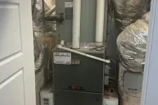 Thumbnail for Residential furnace system with ductwork and insulated pipes in a utility room with concrete floor