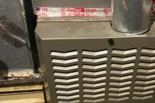 Thumbnail for AC Cooling Repair in Atlanta Brookhaven 30319 by The Air Company of GA.  Bryant furnace with vent pipe and warning labels in a basement utility area with tools nearby.