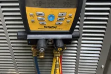 Thumbnail for Fieldpiece SMAN refrigerant manifold gauge attached to HVAC unit with blue, yellow, red hoses measuring pressure and vacuum