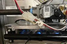 Thumbnail for AC Repair in Roswell GA by The Air Company of GA. Close-up of complex furnace wiring and control components inside metal casing with various wires and circuit boards.