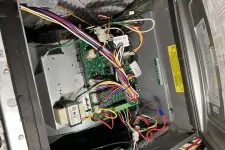 Thumbnail for Open electronic control box with colorful wires connected to a green circuit board inside a metal casing.