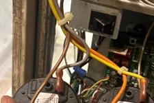 Thumbnail for AC Cooling Repair in Atlanta Brookhaven 30319 by The Air Company of GA.  Hand holding Honeywell low and high fire pressure switches with connected wires inside HVAC system.