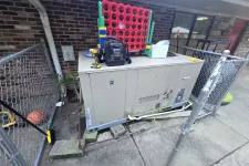 Thumbnail for Commercial HVAC Heating Repair in Roswell 30075 by The Air Company of GAar a brick wall and chain link fence.