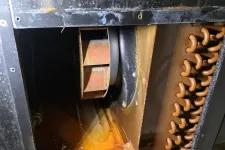 Thumbnail for Rusty HVAC unit interior showing a corroded fan and copper coil with water damage and buildup.