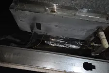 Thumbnail for Close-up of an HVAC unit's metal components showing ductwork, insulation, and a white PVC drain pipe.