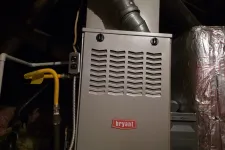 Thumbnail for Bryant furnace unit with ductwork installed in a residential attic space with insulation and pipes.