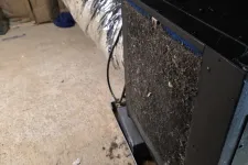 Thumbnail for Dirty HVAC air filter clogged with dust and debris in a basement with ductwork and concrete floor.