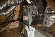 Thumbnail for Furnace and HVAC ductwork installed in a wooden attic with insulation and exposed beams.