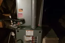 Thumbnail for Residential furnace unit with ductwork and ventilation pipes in an attic space.